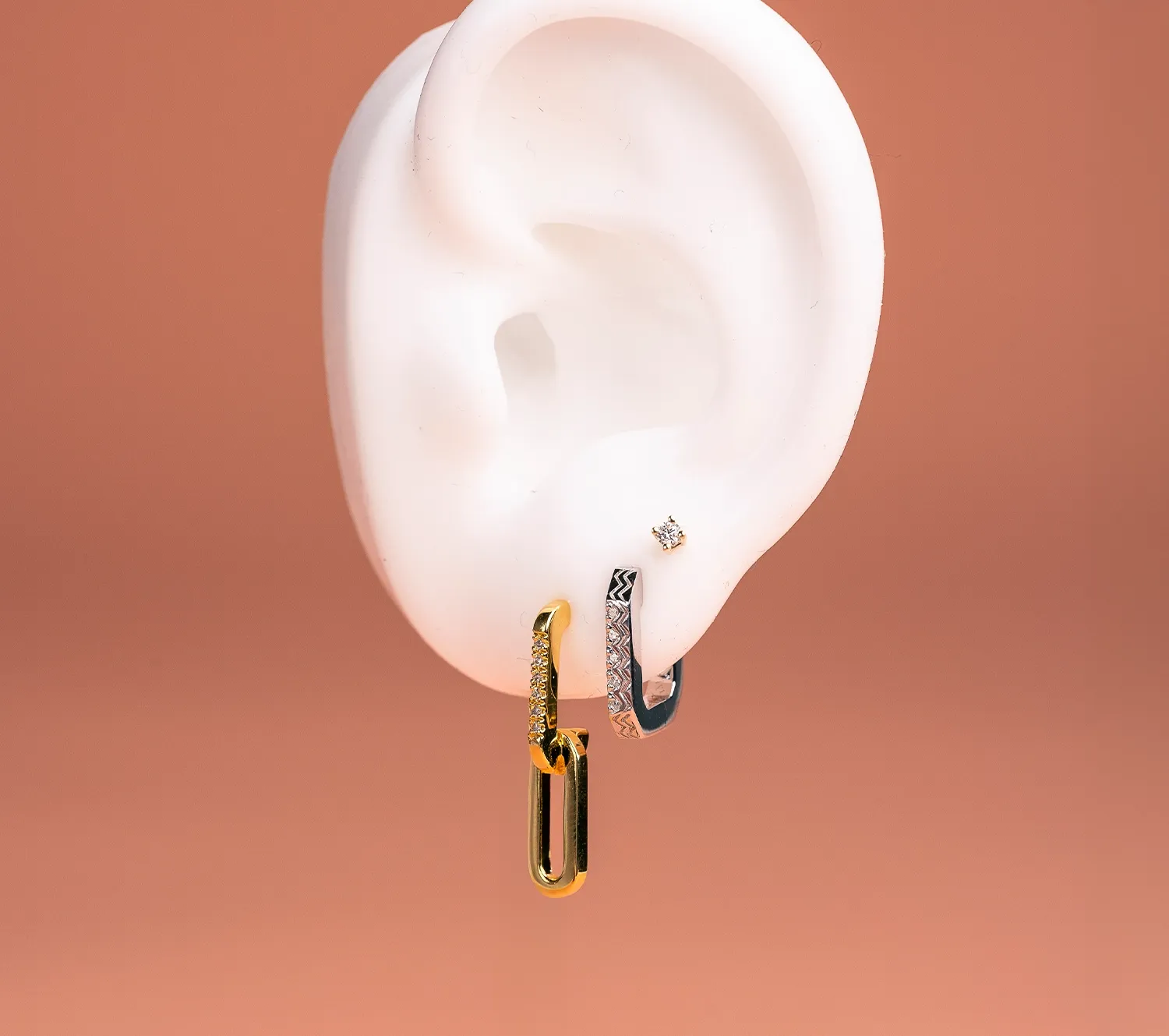 three earrings on one ear