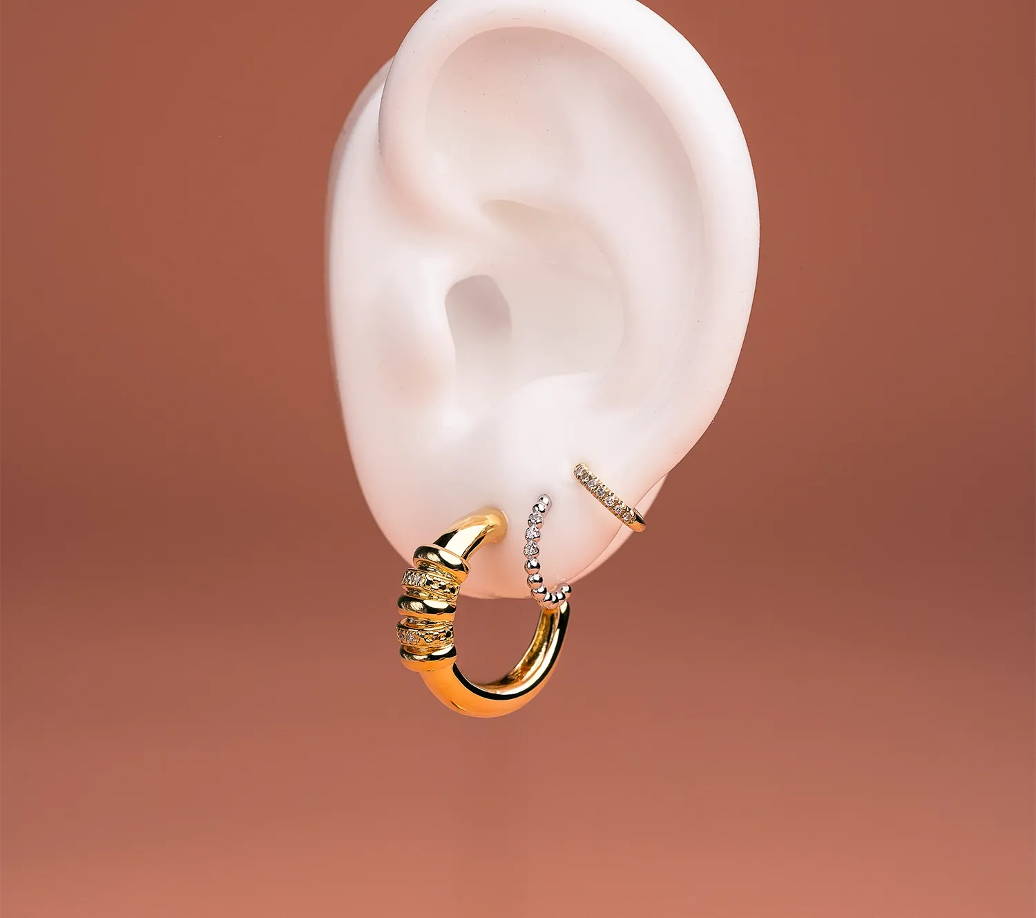 three earrings on one ear