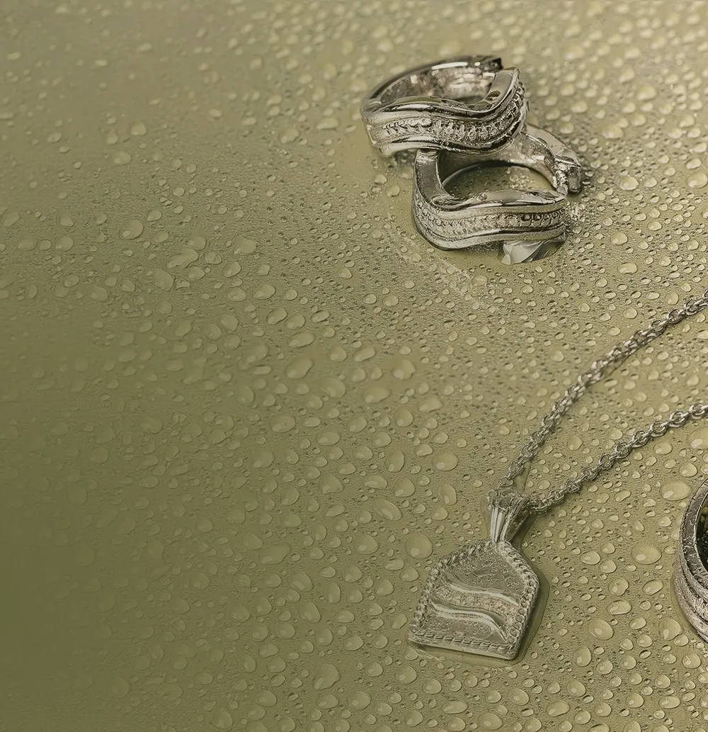 silver ondine jewelry with water drops on green background