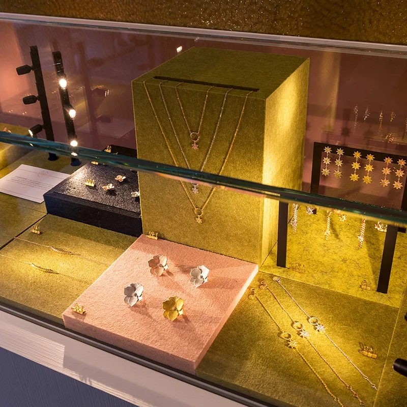 silver and gold jewelry set in a shop display